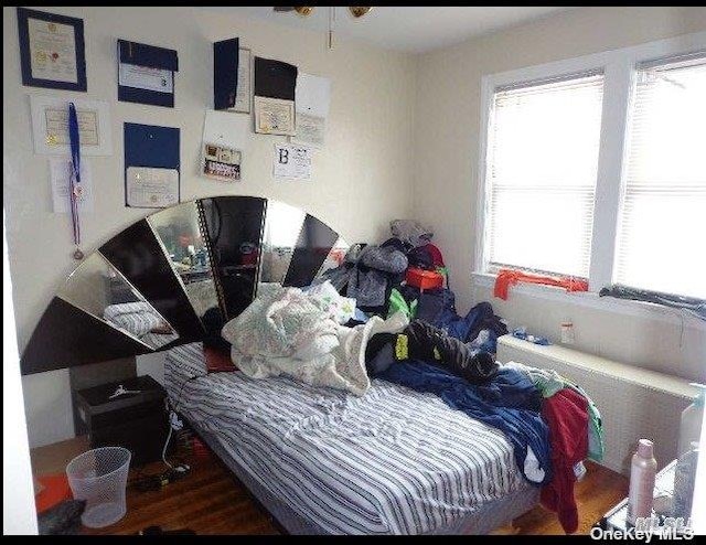 bedroom with hardwood / wood-style flooring