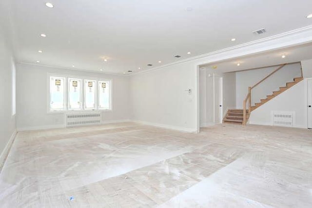 empty room featuring crown molding, recessed lighting, radiator heating unit, baseboards, and stairs