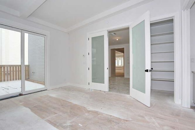 spare room with plenty of natural light and french doors