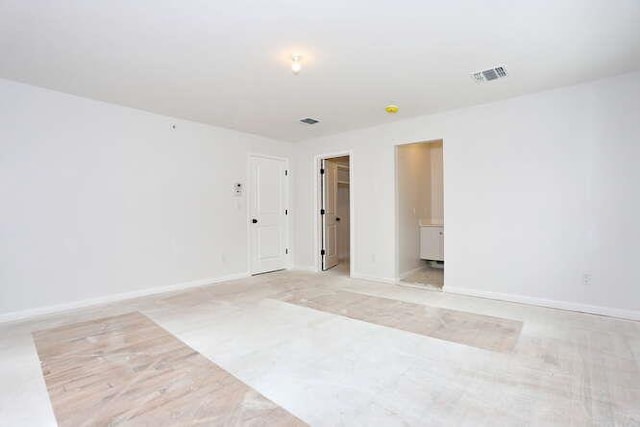 empty room with baseboards and visible vents