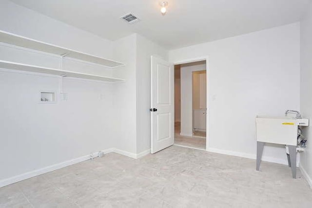 laundry room featuring laundry area, washer hookup, visible vents, and baseboards