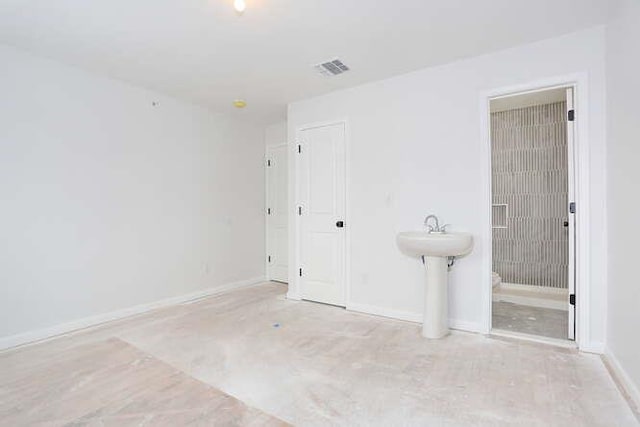 unfurnished bedroom with visible vents and baseboards