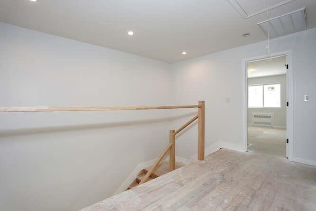 hall with attic access, recessed lighting, baseboards, and an upstairs landing