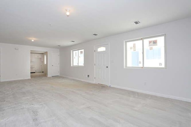 spare room with visible vents and baseboards