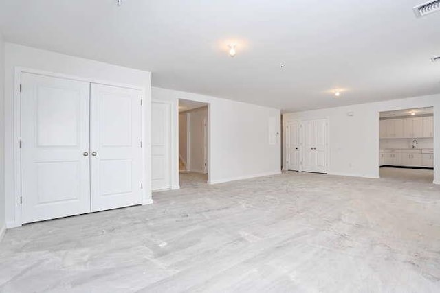 unfurnished bedroom featuring baseboards, visible vents, and a closet