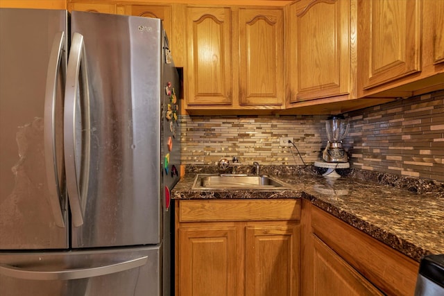 kitchen with sink, stainless steel refrigerator, and decorative backsplash