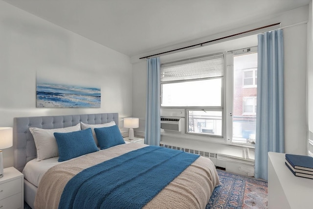 bedroom featuring cooling unit and radiator heating unit