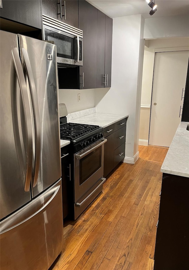 kitchen with appliances with stainless steel finishes and light wood-type flooring