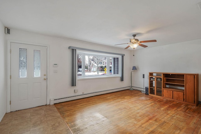 unfurnished living room featuring wood-type flooring, ceiling fan, and baseboard heating