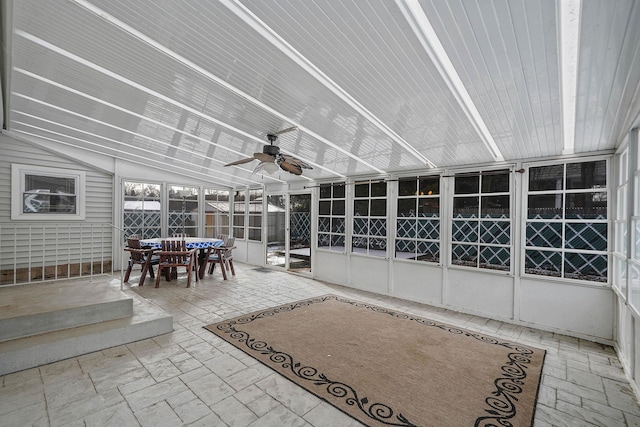 unfurnished sunroom with lofted ceiling and ceiling fan