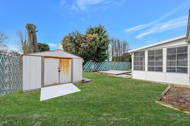 view of yard with a sunroom and a storage unit