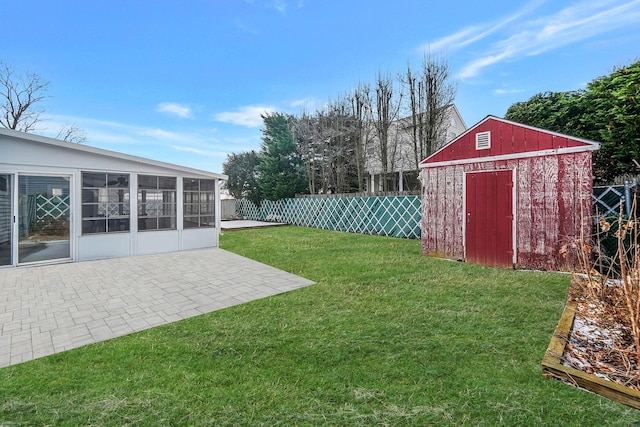 view of yard featuring a storage unit and a patio