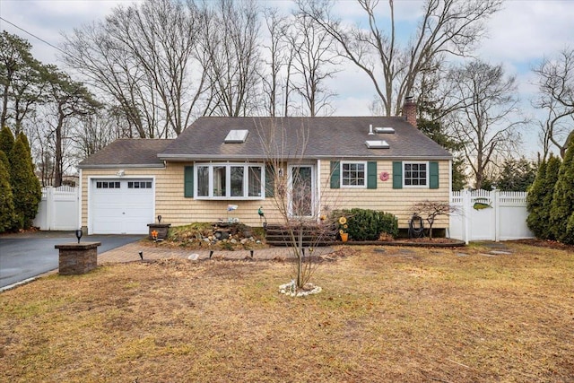 ranch-style house featuring a garage and a front yard