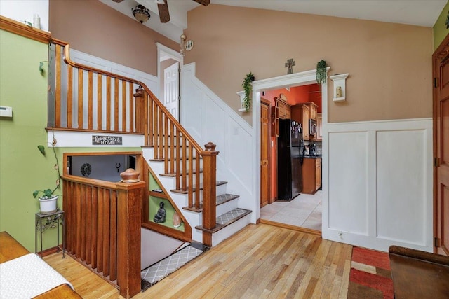 stairway with lofted ceiling and wood-type flooring