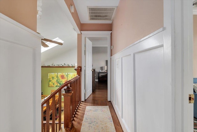 hall with lofted ceiling and dark hardwood / wood-style floors