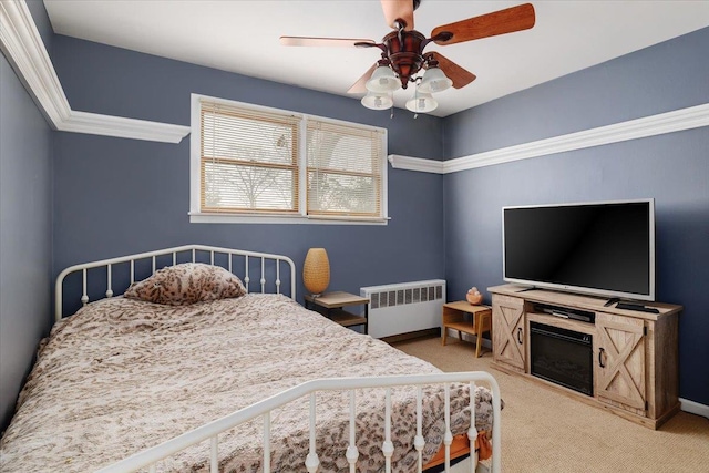 bedroom featuring radiator, light colored carpet, and ceiling fan