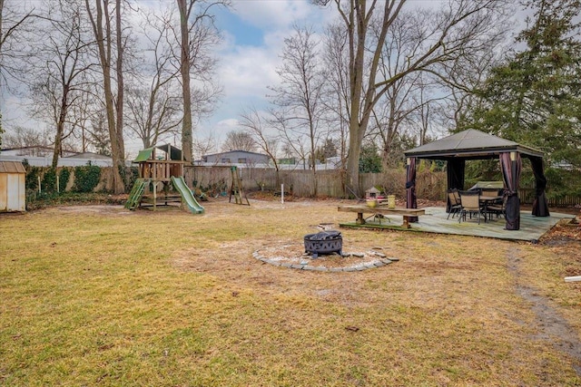 view of yard with a fire pit, a playground, and a gazebo