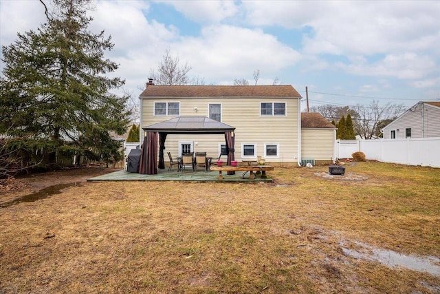 back of house featuring a gazebo, a lawn, a patio, and an outdoor fire pit