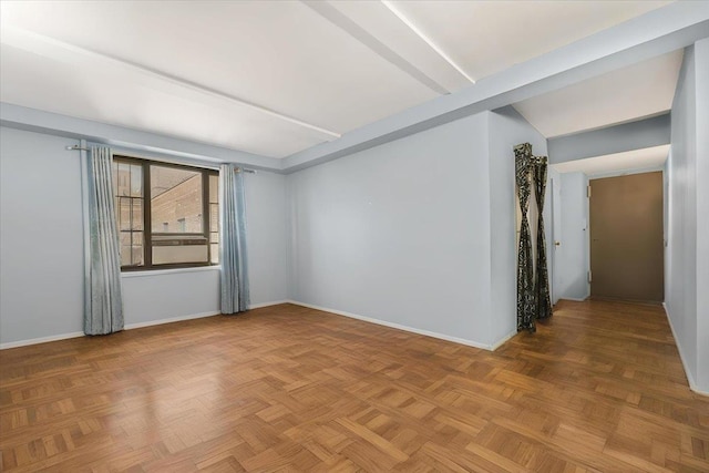 unfurnished room featuring parquet flooring and beam ceiling