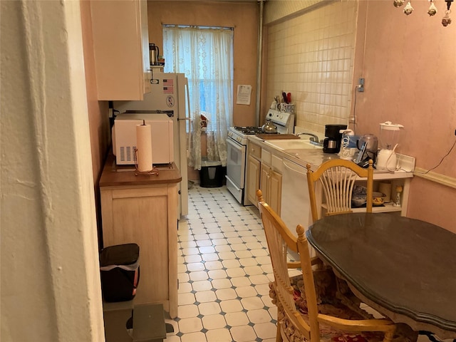 kitchen featuring sink and white appliances