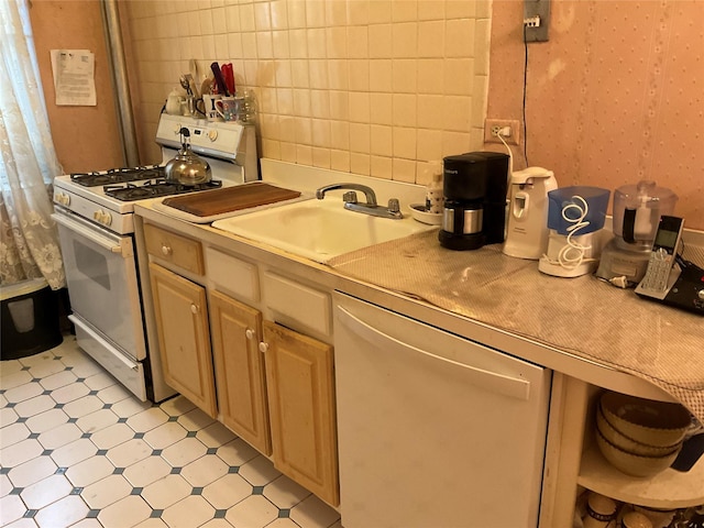 kitchen with sink, white appliances, decorative backsplash, and light brown cabinets