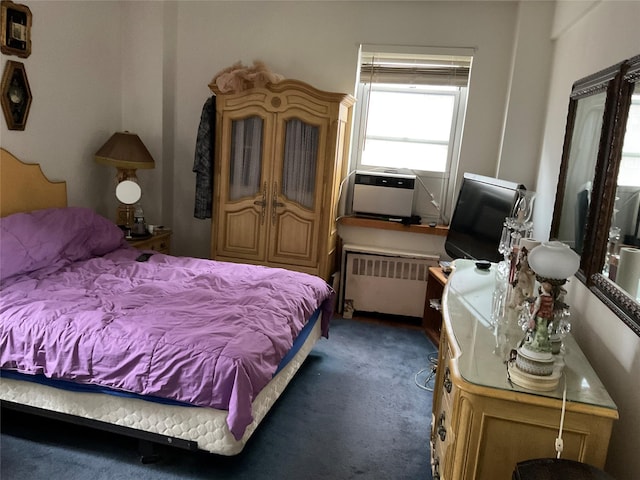 carpeted bedroom featuring cooling unit and radiator heating unit