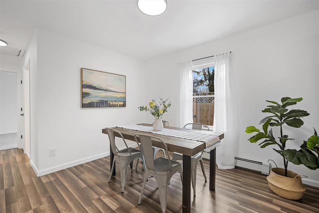 dining room featuring dark wood-type flooring and a baseboard radiator