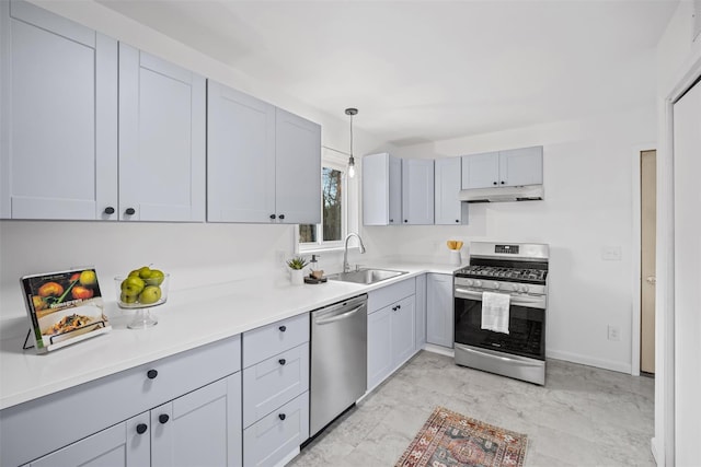 kitchen featuring appliances with stainless steel finishes, sink, hanging light fixtures, and gray cabinetry