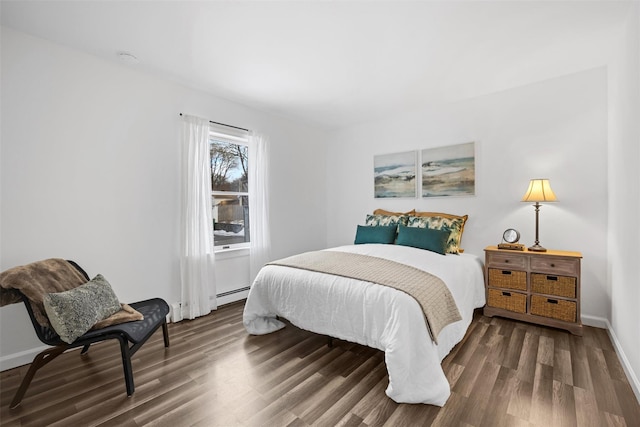 bedroom with a baseboard radiator and dark hardwood / wood-style flooring