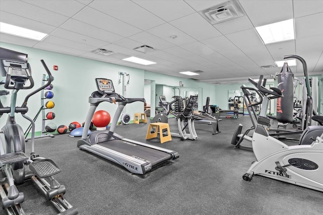 gym with a paneled ceiling