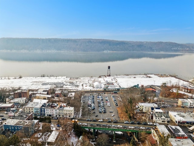 snowy aerial view featuring a water view