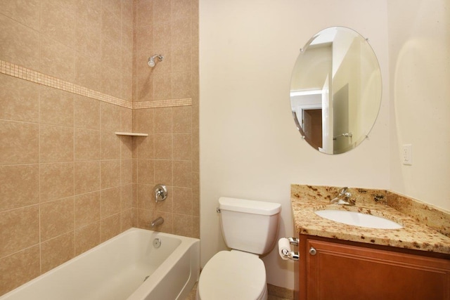 full bathroom with vanity, tiled shower / bath combo, and toilet