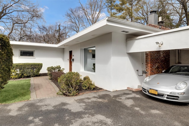 entrance to property with brick siding and stucco siding