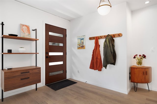 entryway with recessed lighting, wood finished floors, and baseboards