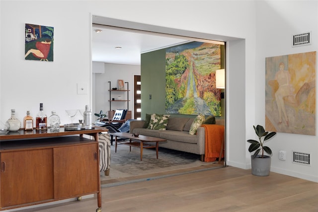 interior space featuring visible vents, baseboards, and light wood-style floors