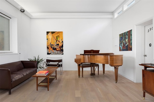 sitting room with baseboards and light wood-style floors