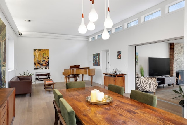 dining room featuring a fireplace and light wood finished floors