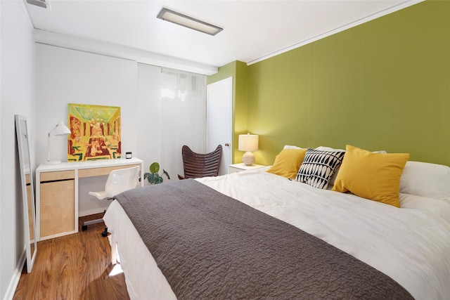 bedroom featuring wood finished floors