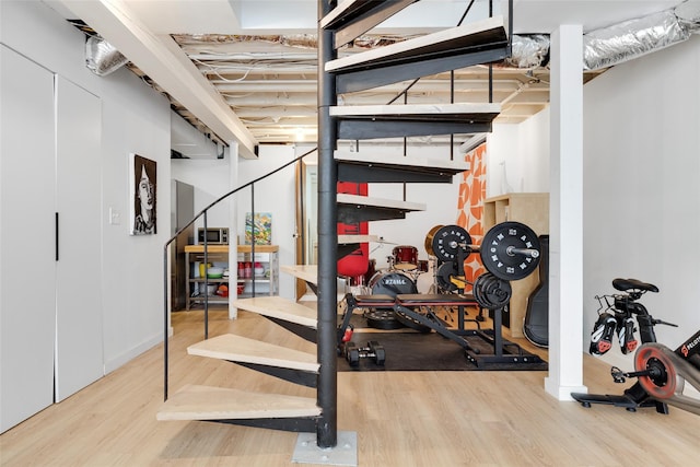 exercise room with wood finished floors