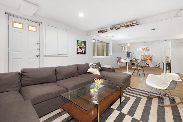 living room featuring visible vents and light wood-type flooring