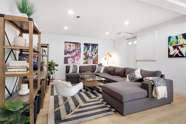 living room featuring recessed lighting, light wood-style flooring, and baseboards