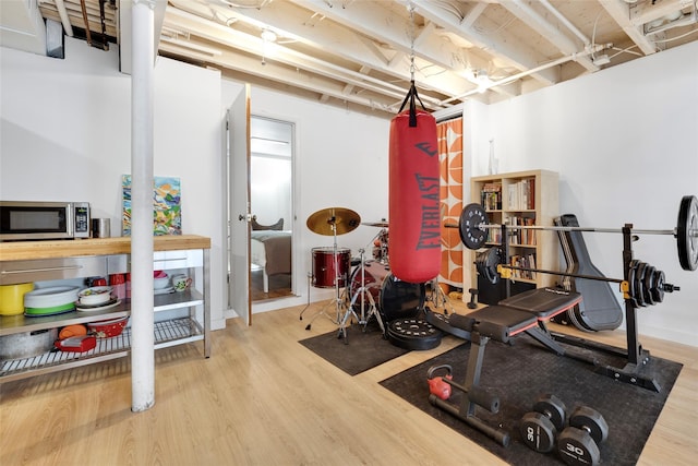 workout area with wood finished floors