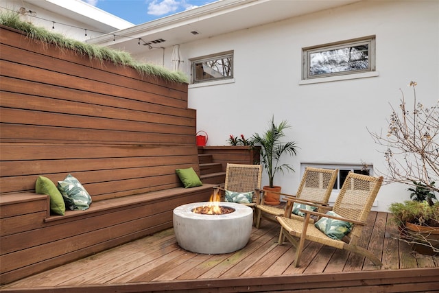 wooden terrace with a fire pit