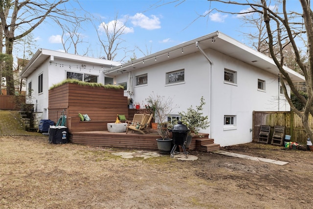 back of house featuring stucco siding