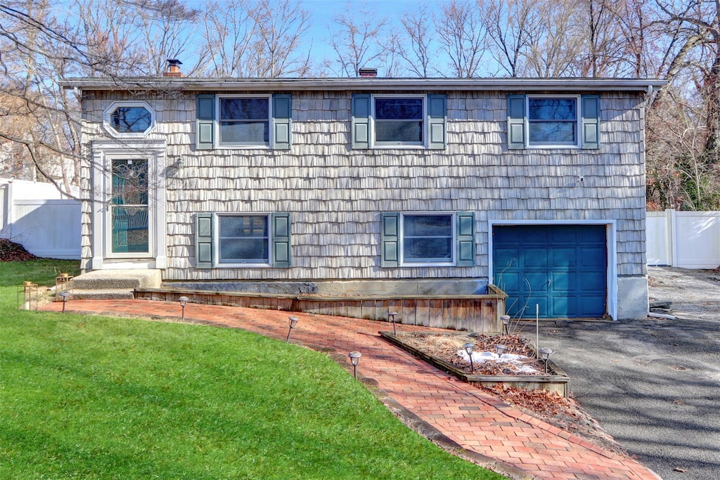 view of front of property featuring a garage and a front yard