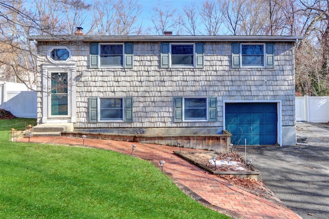 view of front of property featuring a garage and a front yard