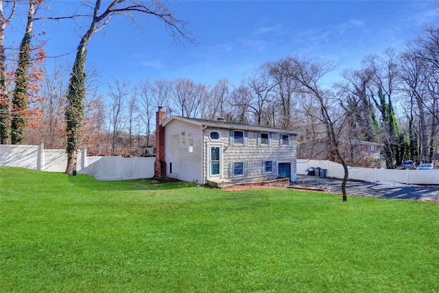 back of property featuring a lawn