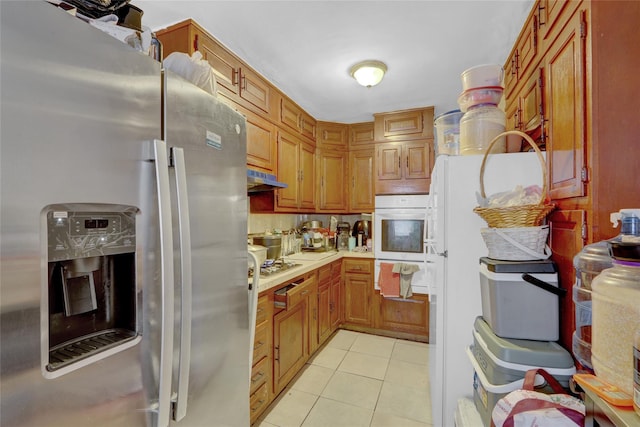 kitchen with light tile patterned flooring and appliances with stainless steel finishes