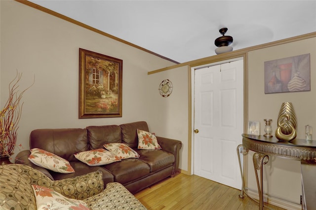 living room featuring crown molding and light wood-type flooring