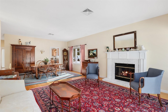 living room featuring a fireplace and light hardwood / wood-style flooring